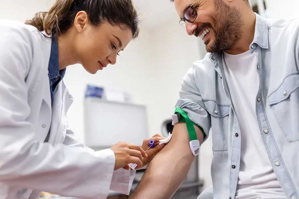 Phlebotomy Technician Beautiful Young Woman Drawing Blood from Male Patient